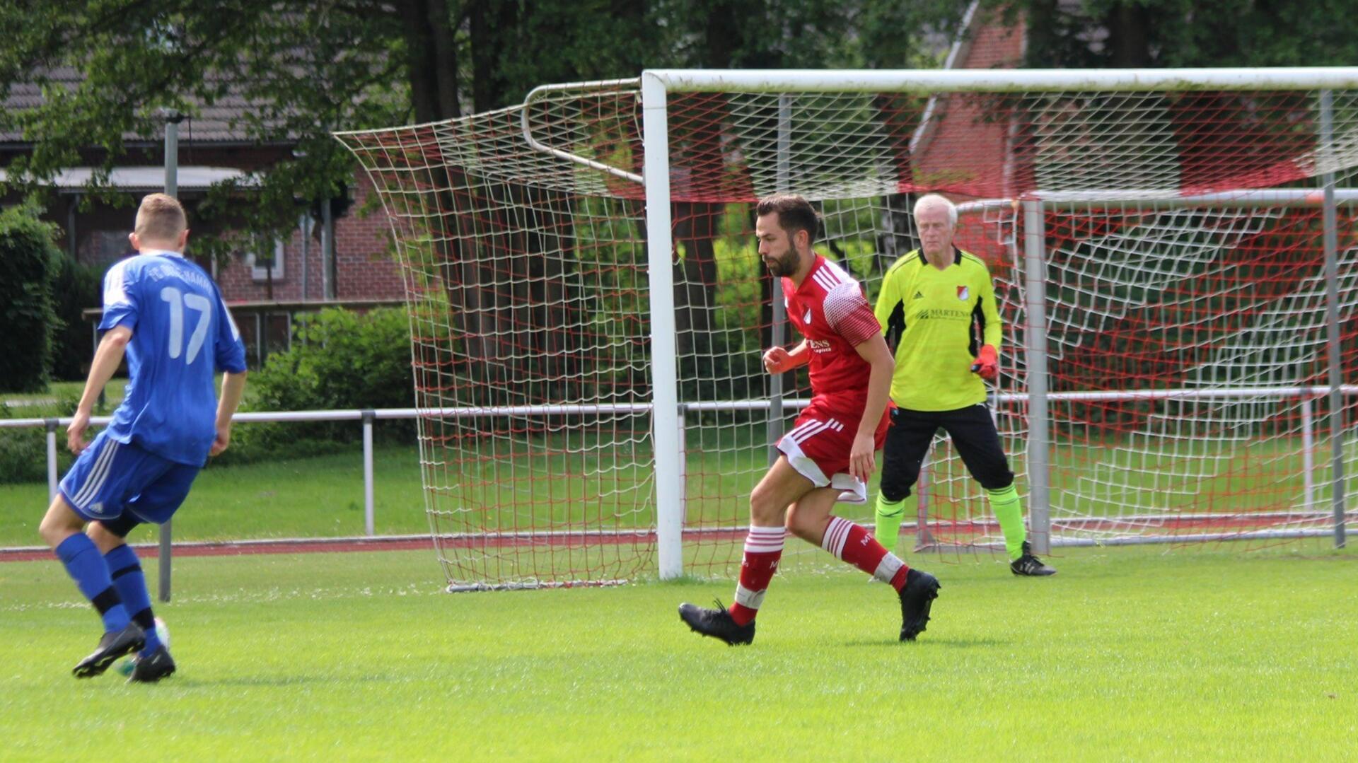 drei Männer vor einem Fußballtor