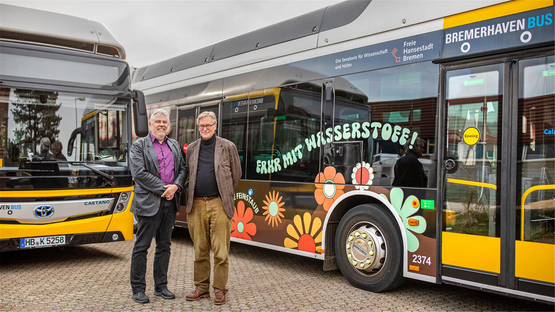 Zwei Männer vor Bussen.