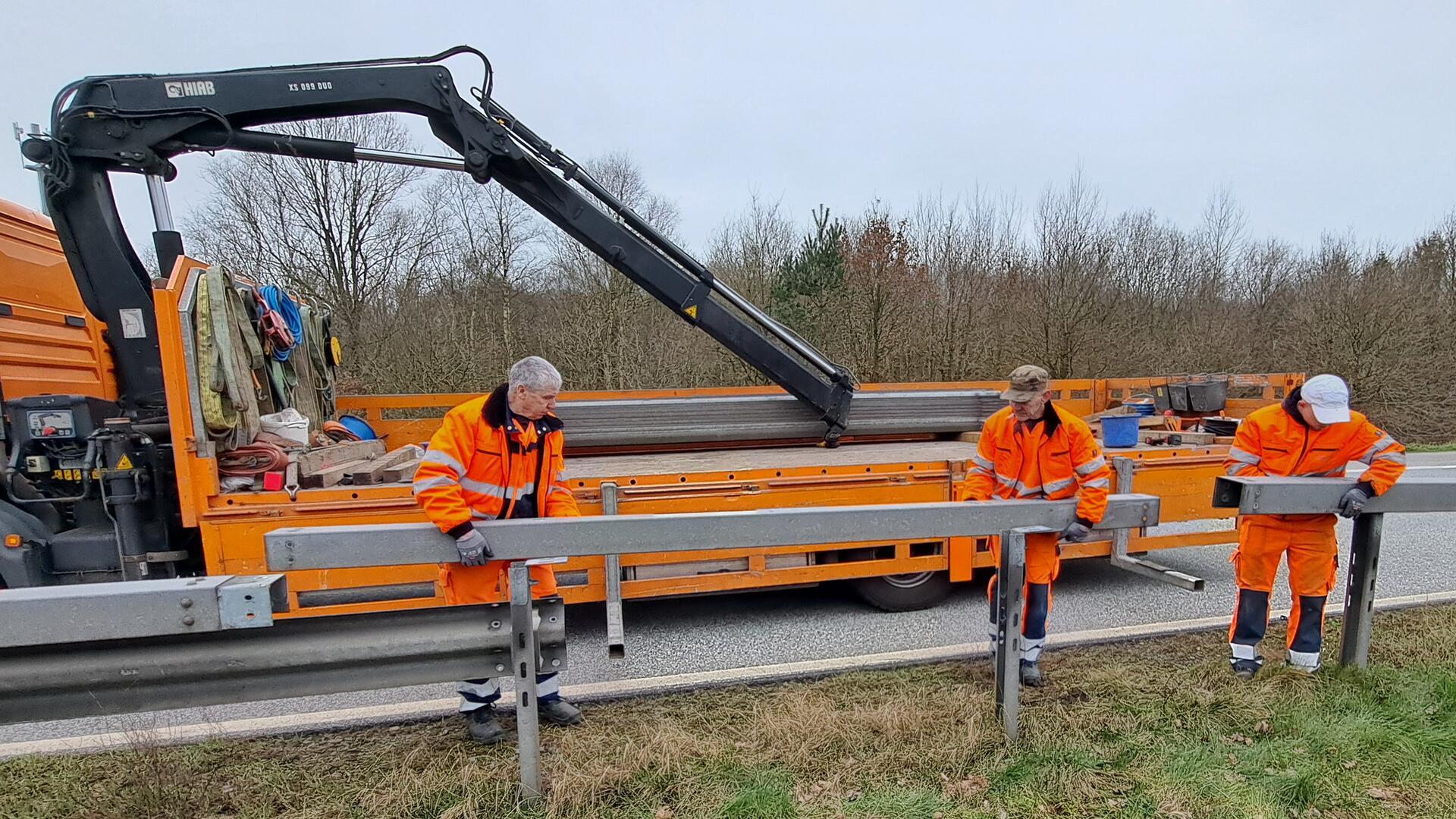 Bevor die Baugrube ausgehoben werden kann, um das 50 Jahre alte Stahlrohr zu ersetzen, entfernen Bauarbeiter die Leitplanken an der Autobahn 27