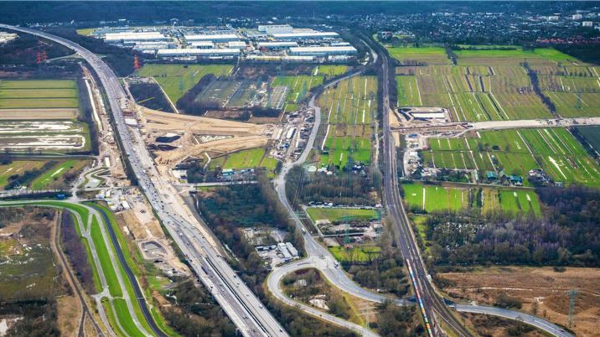 Das Bild zeigt die Großbaustelle Autobahnkreuz Hamburg-Hafen im Zuge der A7. Rechts ist die Hafenbahn zu sehen. Der Tunnel unter dieser Bahnlinie für die A26 ist ein Grund, warum sich der Bau verzögert.