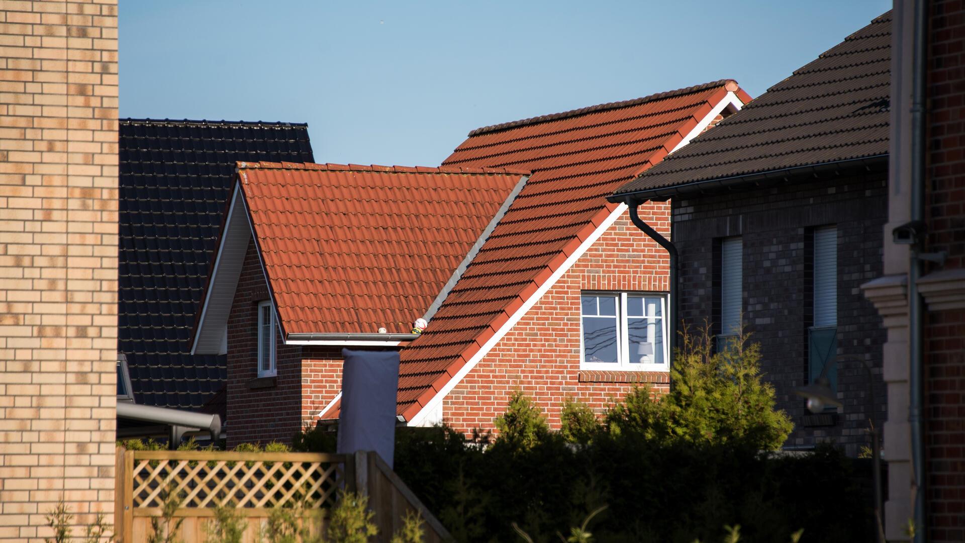 Ein Wohnhaus steht in einem Neubaugebiet. 