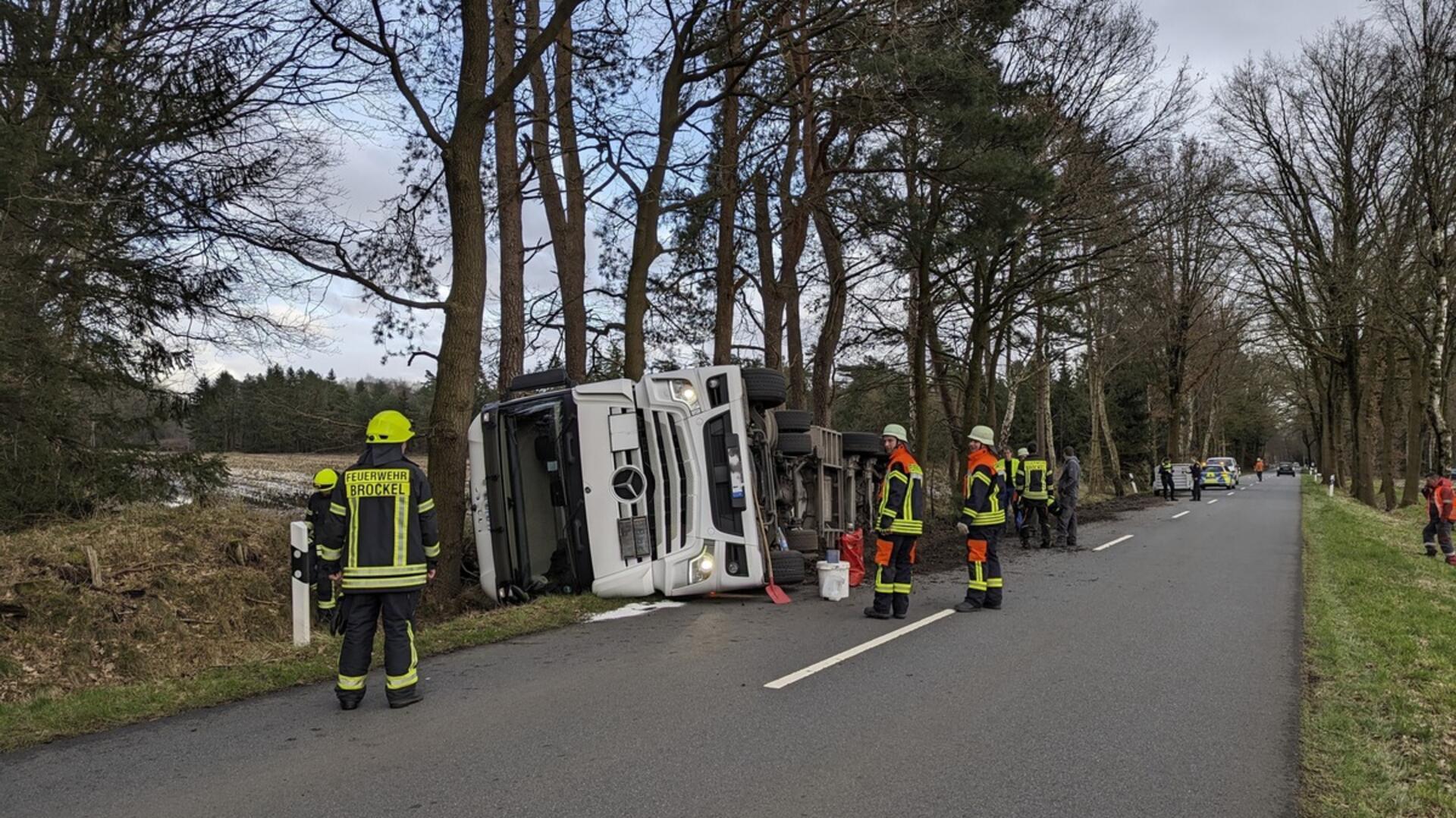 Der umgekippte Tanklastzug im Trochel bei Brockel. Einsatzkräfte von Polizei und Feuerwehr sichern die Unfallstelle ab.