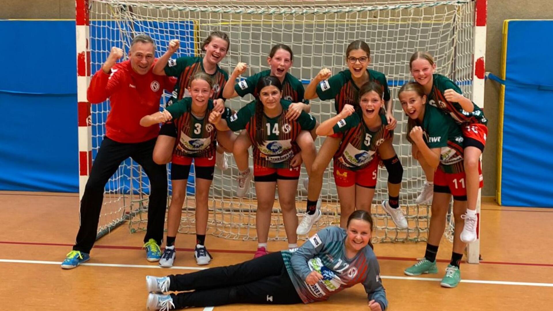 Die D-Jugendhandballerinnen und Trainer Stefan Pragmann jubeln: Sie haben sich für die Regionsoberliga qualifiziert.