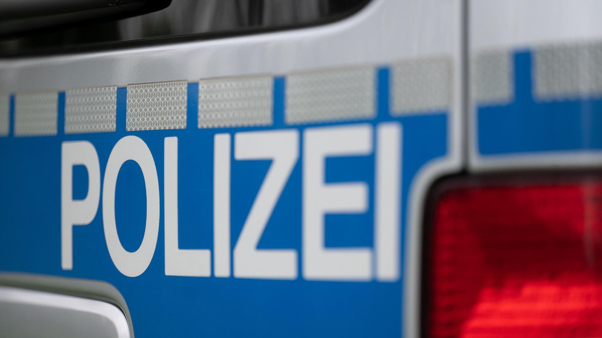 Blauer Hintergrund und die weiße Aufschrift Polizei.