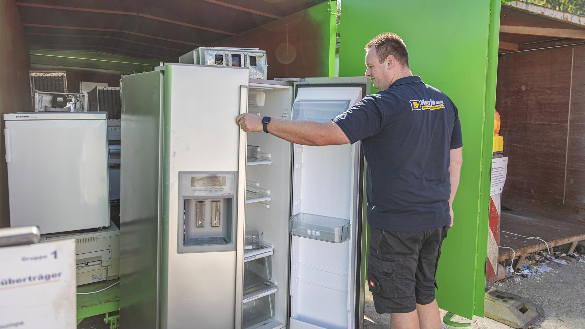 Ein Mann schaut in einen leeren Kühlschrank