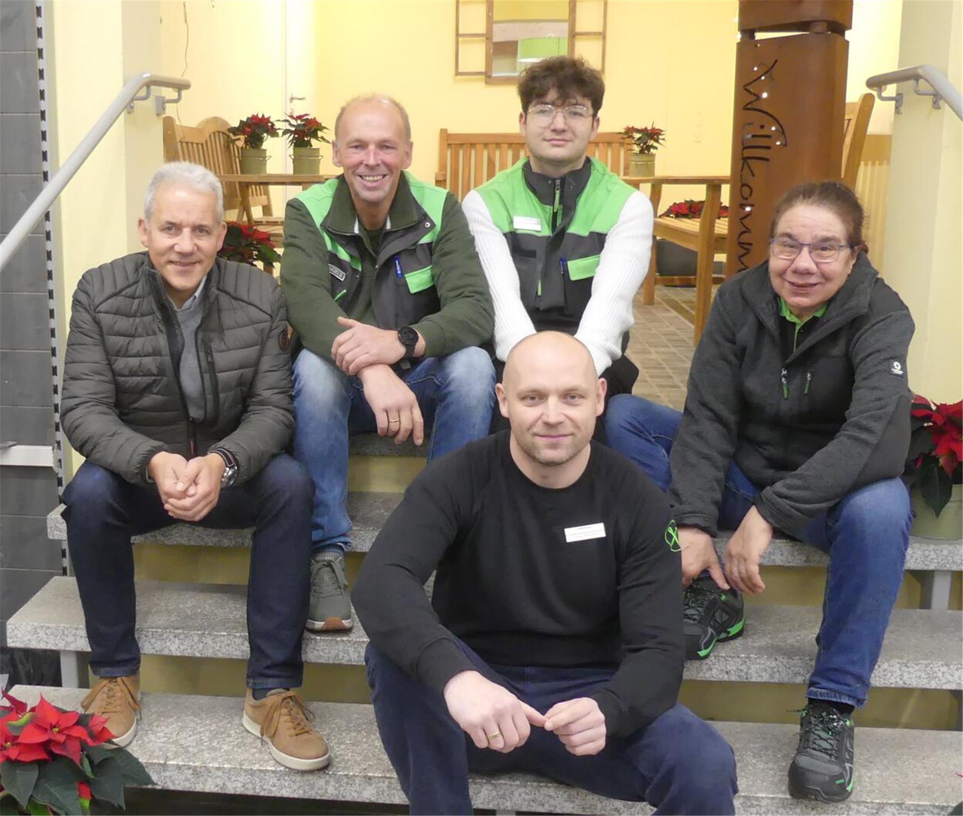 Gruppenfoto mehrere Leute sitzen auf einer Treppe