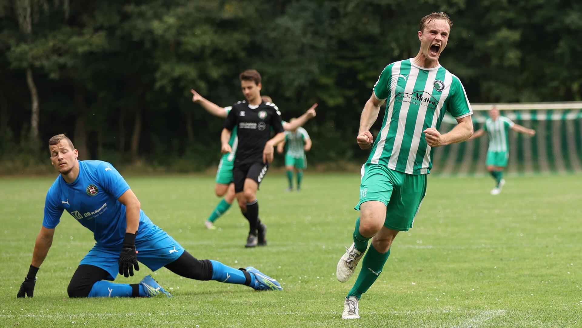 Moritz Janning schreit seine Freude heraus: soeben hat der Karlshöfener Nordheides Nico Hüttmann überwunden und den 2:1-Siegtreffer für den TSV Karlshöfen erzielt.