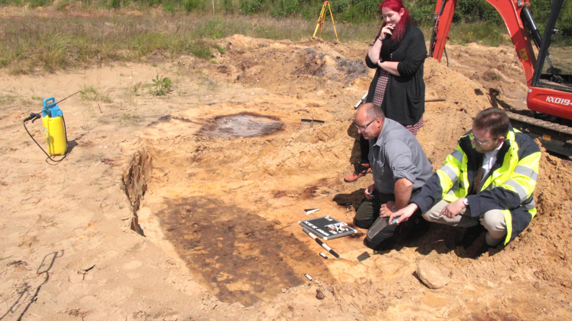 Nur Schatten von Leiche und Sarg blieben im Sand. Von rechts: Kreisarchäologe Dr. Stefan Hesse, Grabungstechniker Ingo Neumann und Gesa Richter.