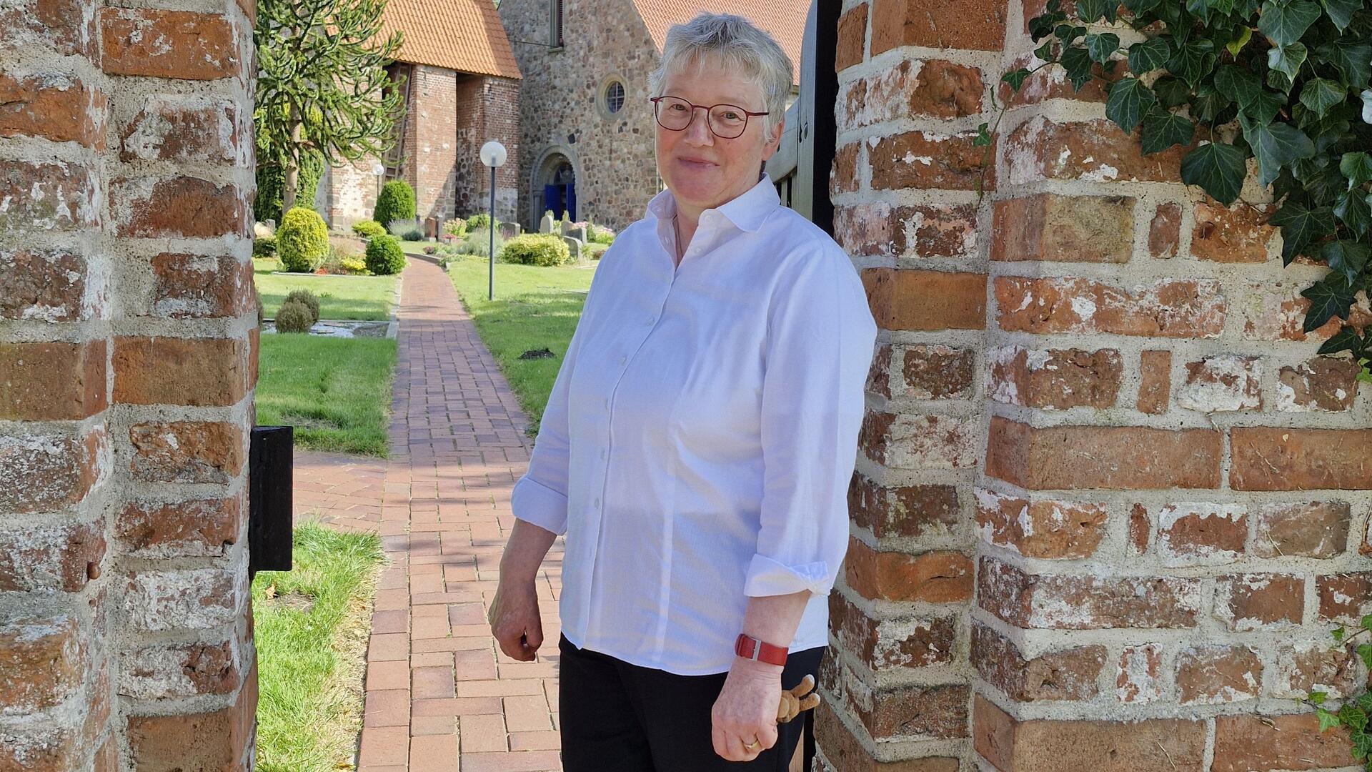 Christa Maschke vor der schönen Kirche in Debstedt.